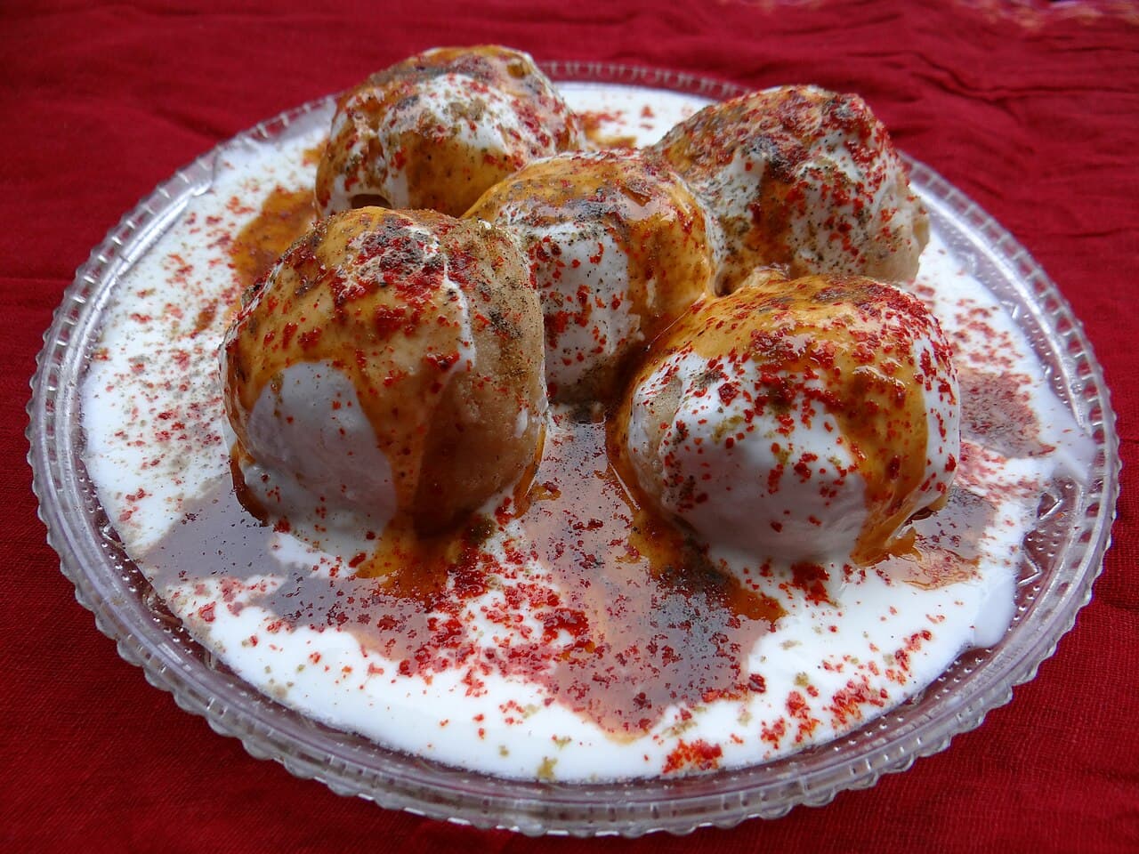 A plate of Dahi Bara — soft lentil dumplings in chilled yoghurt with tamarind and chaat masala